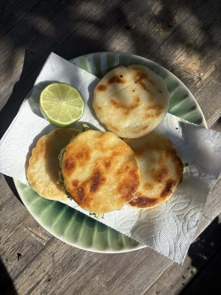 This image shows an Arepa Reina Pepiada made with chicken and avocado