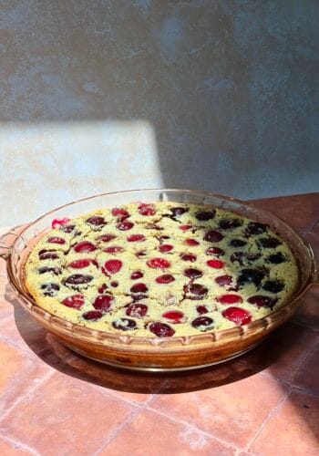 This image sows a cherry clafoutis on that just came out of the oven.